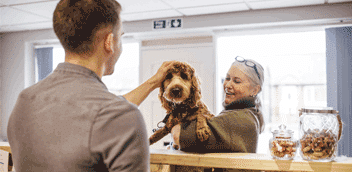 Pet resort owner greeting a customer